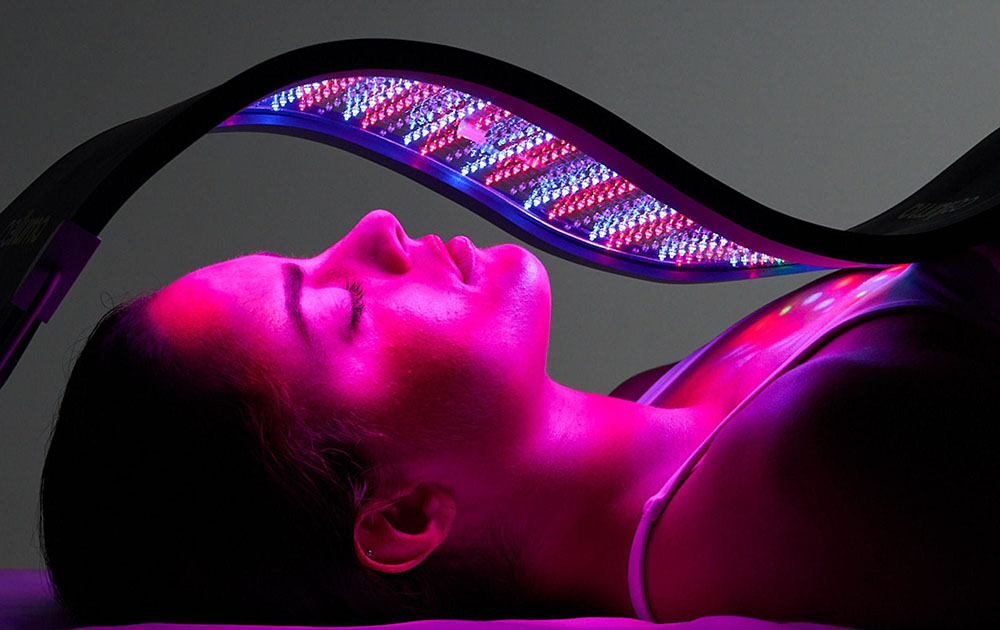 Woman getting Red Light Therapy with the Celluma Pro Plus LED light device.
